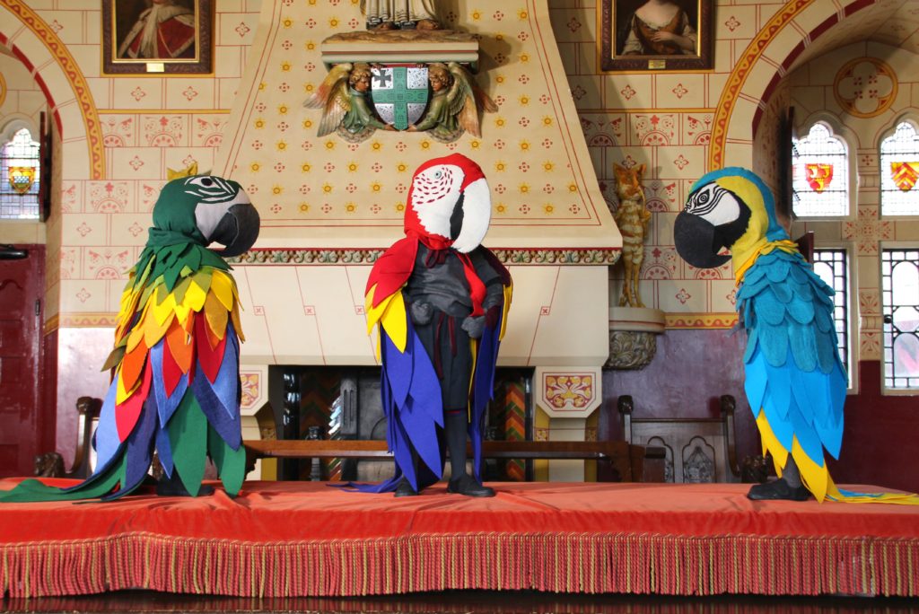 Three sculptures of parrot headed characters by Laura Ford in Castell Coch