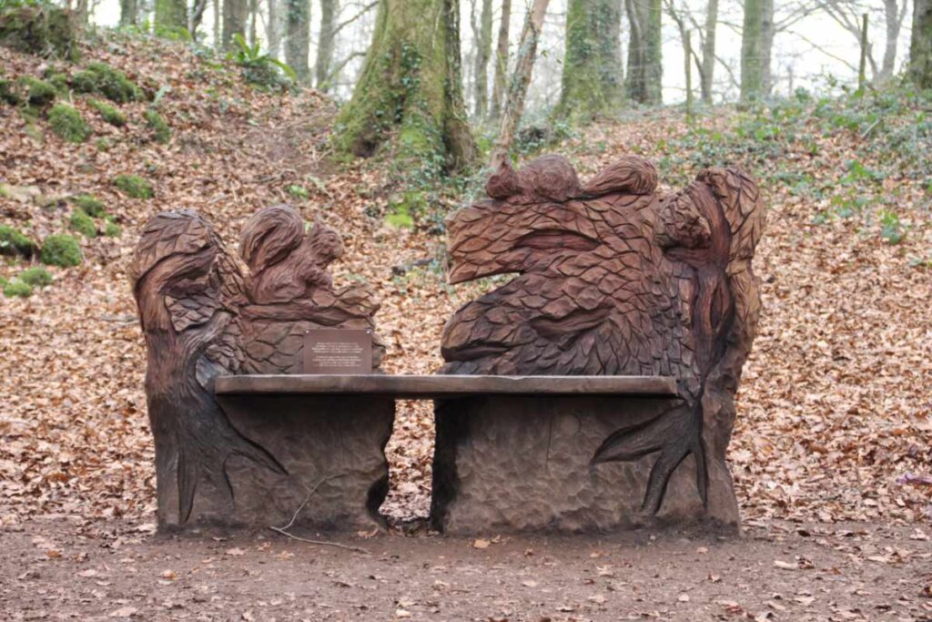 Wooden sculpture of animals on a bench