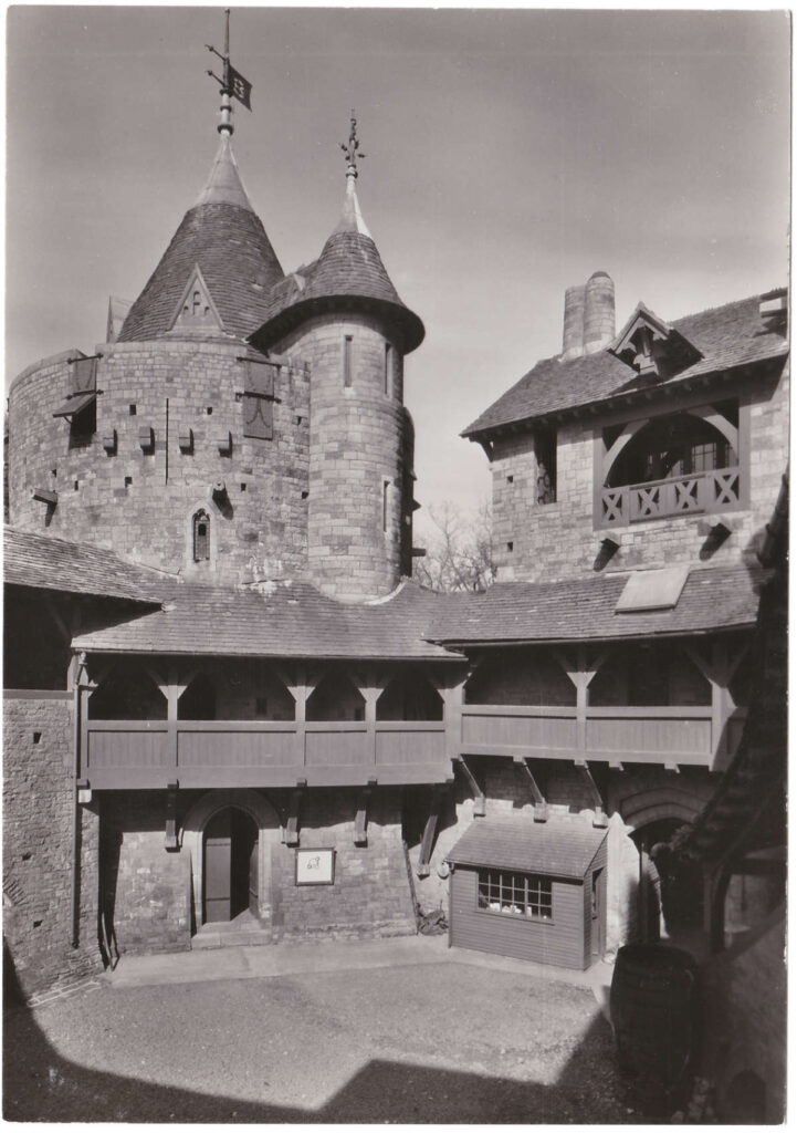 Black and white postcard of the courtyard and Well Tower in Castell Coch