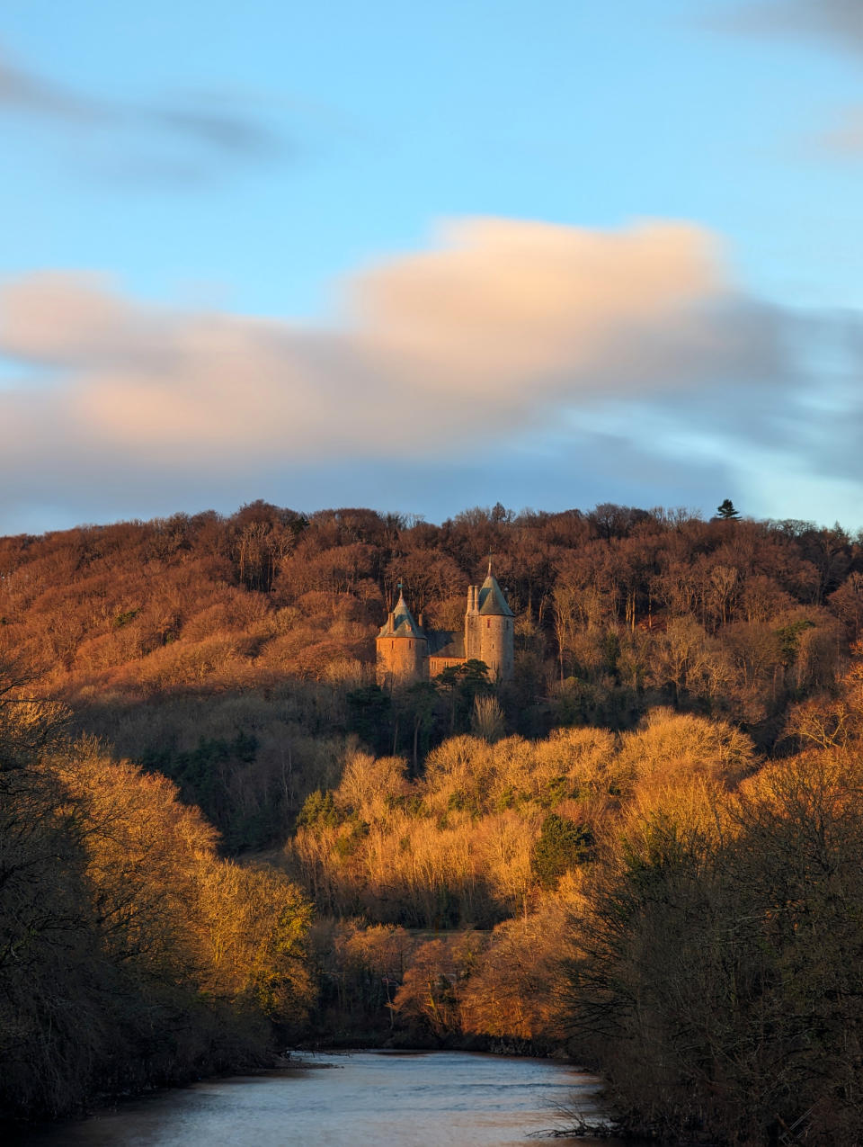 Castell Coch above the River Taff in Tongwynlais, Cardiff. The surrounding forest is a rich autumnal brown.